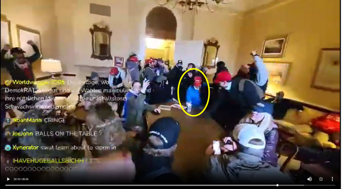 As the crowd chants, Sandra Lee Hodges bangs her fist on a conference room table in the U.S. Capitol building on Jan. 6, 2021. This image is included in an FBI agent’s criminal complaint against Hodges.