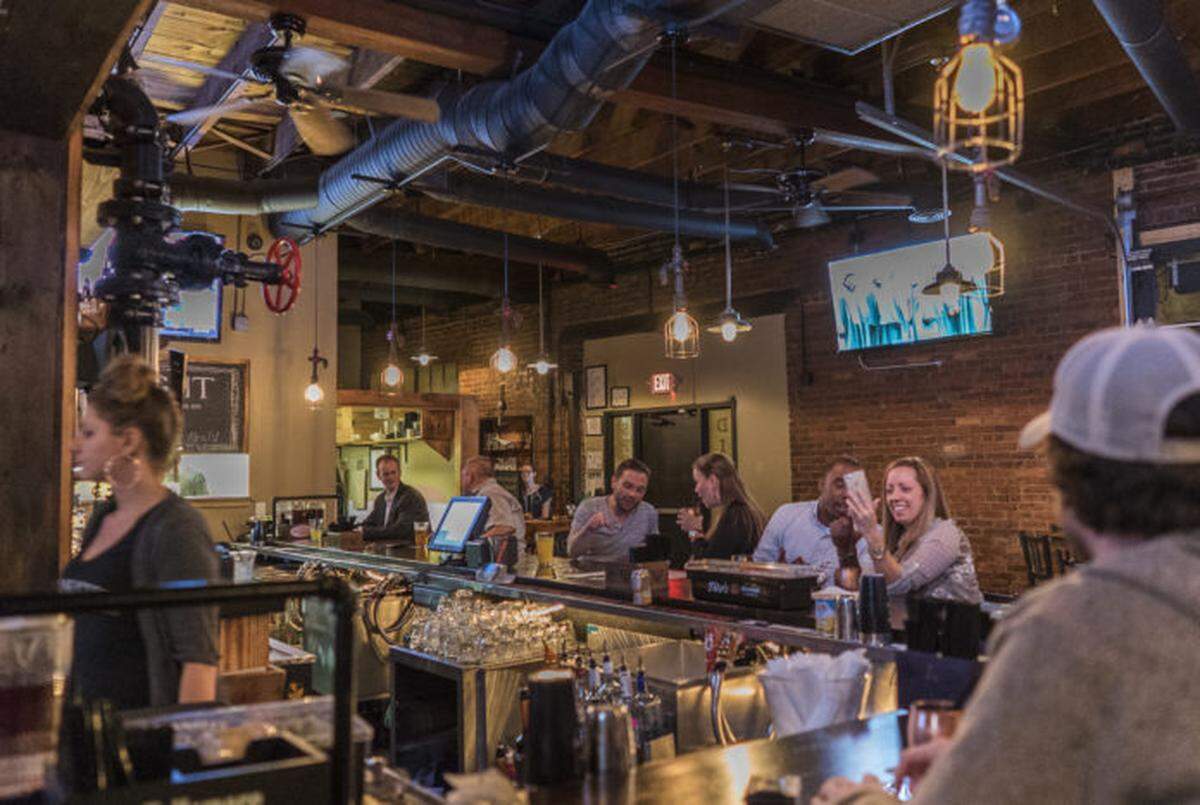 Patrons enjoy the main bar at Draught.