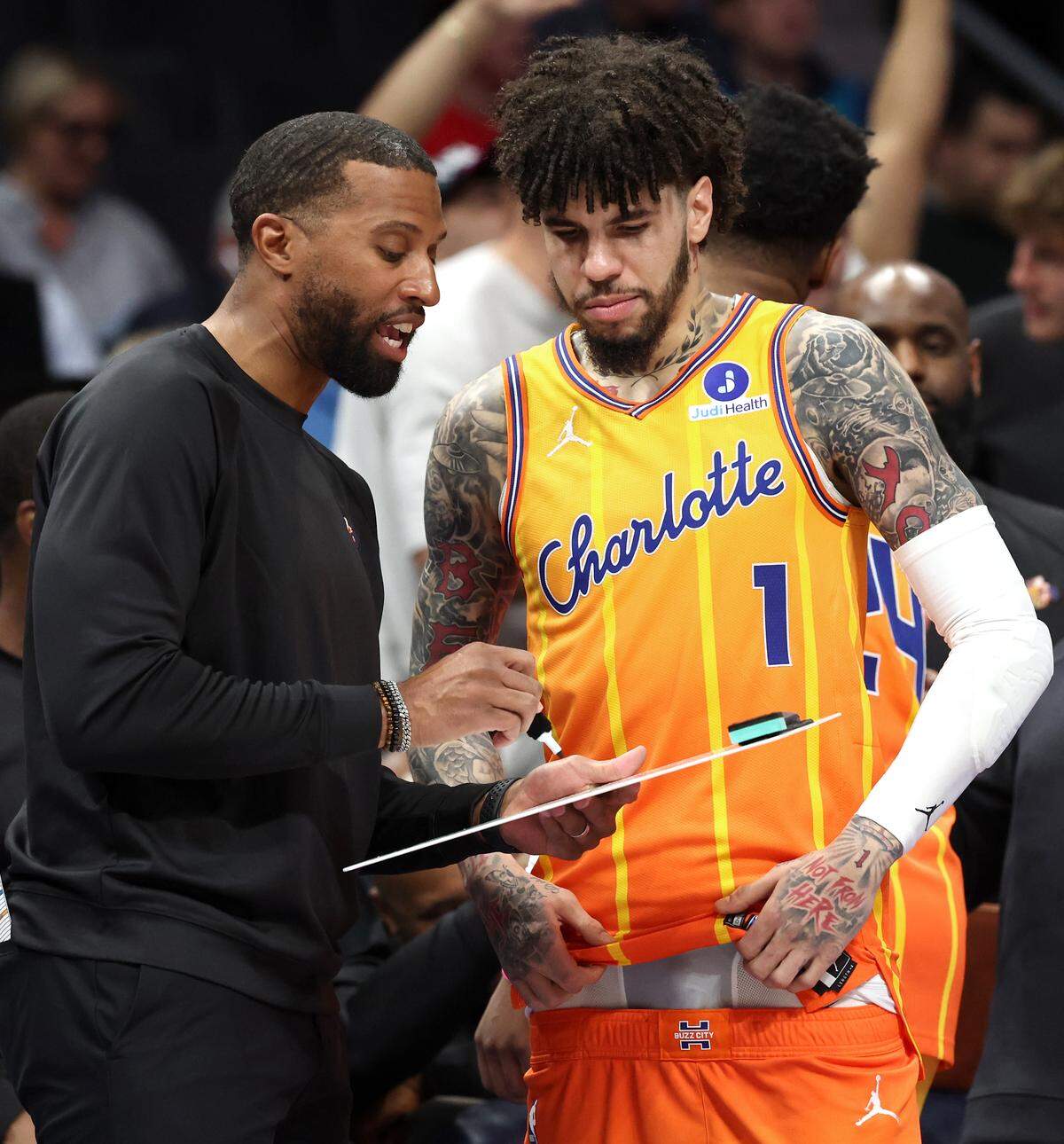 Charlotte Hornets head coach Charles Lee, left, goes over a play with guard LaMelo Ball prior to Thursday’s game against the Houston Rockets at Spectrum Center. Ball was involved in a car wreck on Wednesday at the intersection of Trade and Tryon streets but was unhurt. 