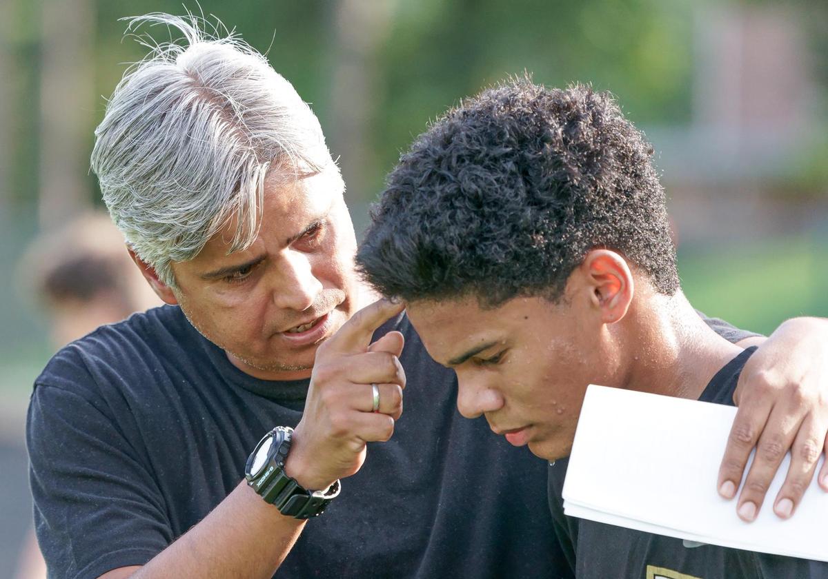 Providence head coach Nicolas Sosa speaks to one of his players prior to kickoff.