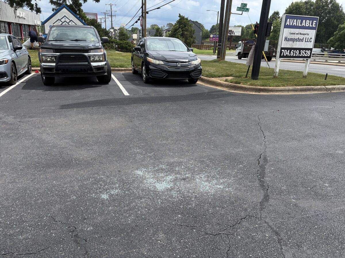 Glass remained on the ground of Wow Supermarket’s parking lot after federal immigration authorities arrested a man in Charlotte on Monday.