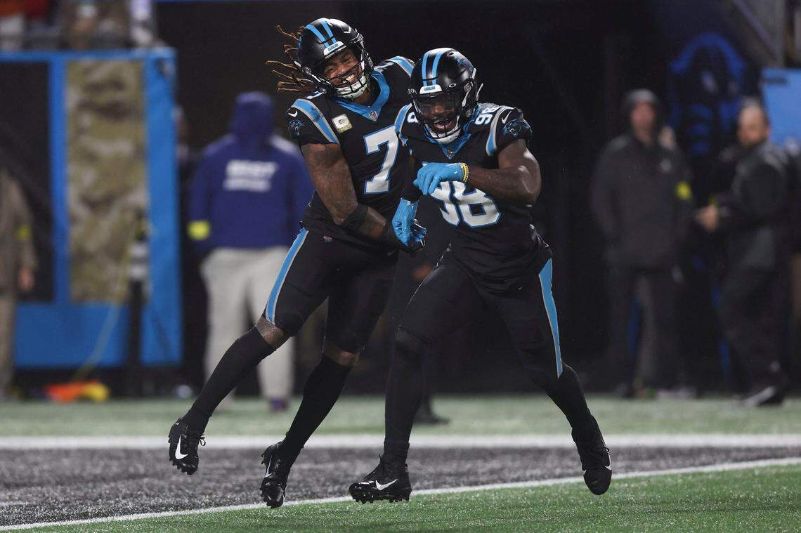 Carolina Panthers linebacker Shaq Thompson, left, celebrates with Carolina Panthers defensive end Marquis Haynes Sr. during a November game against the Atlanta Falcons at Bank of America Stadium.