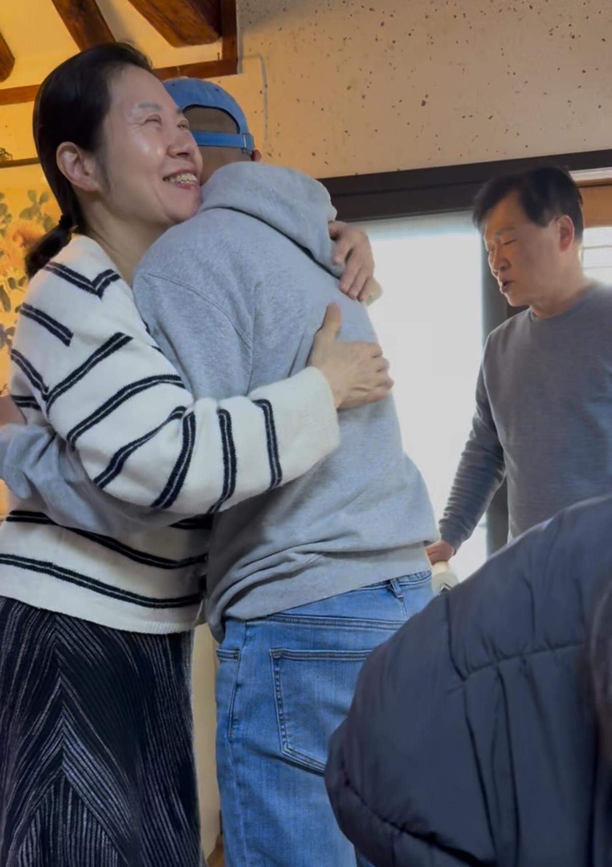 Théoden Janes is greeted by his friends Shin and Lee upon arrival at their traditional Korean hanok in Seoul last month.