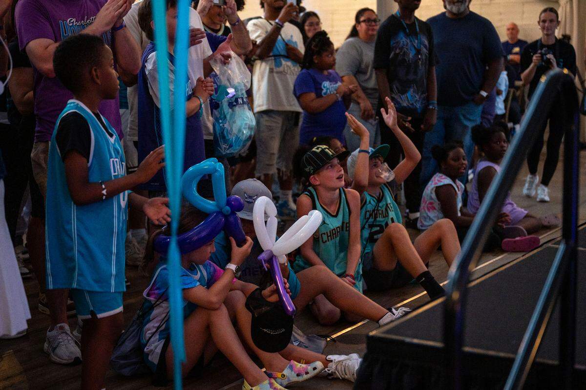 Young Charlotte Hornets fans watch the panel of Eric Collins, Muggsy Bogues and Kemba Walke speak during the Hornets 2025 Draft Party in Charlotte, NC, Wednesday, June 25, 2025.