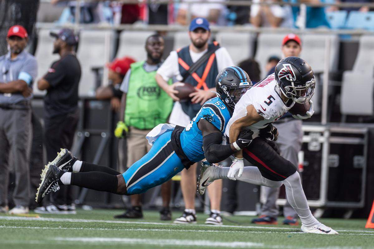 Carolina Panthers linebacker Claudin Cherelus, left, tackles Atlanta Falcons wide receiver Drake London at the Bank of America Stadium in Charlotte, N.C. on Sunday, Oct. 13, 2024. 