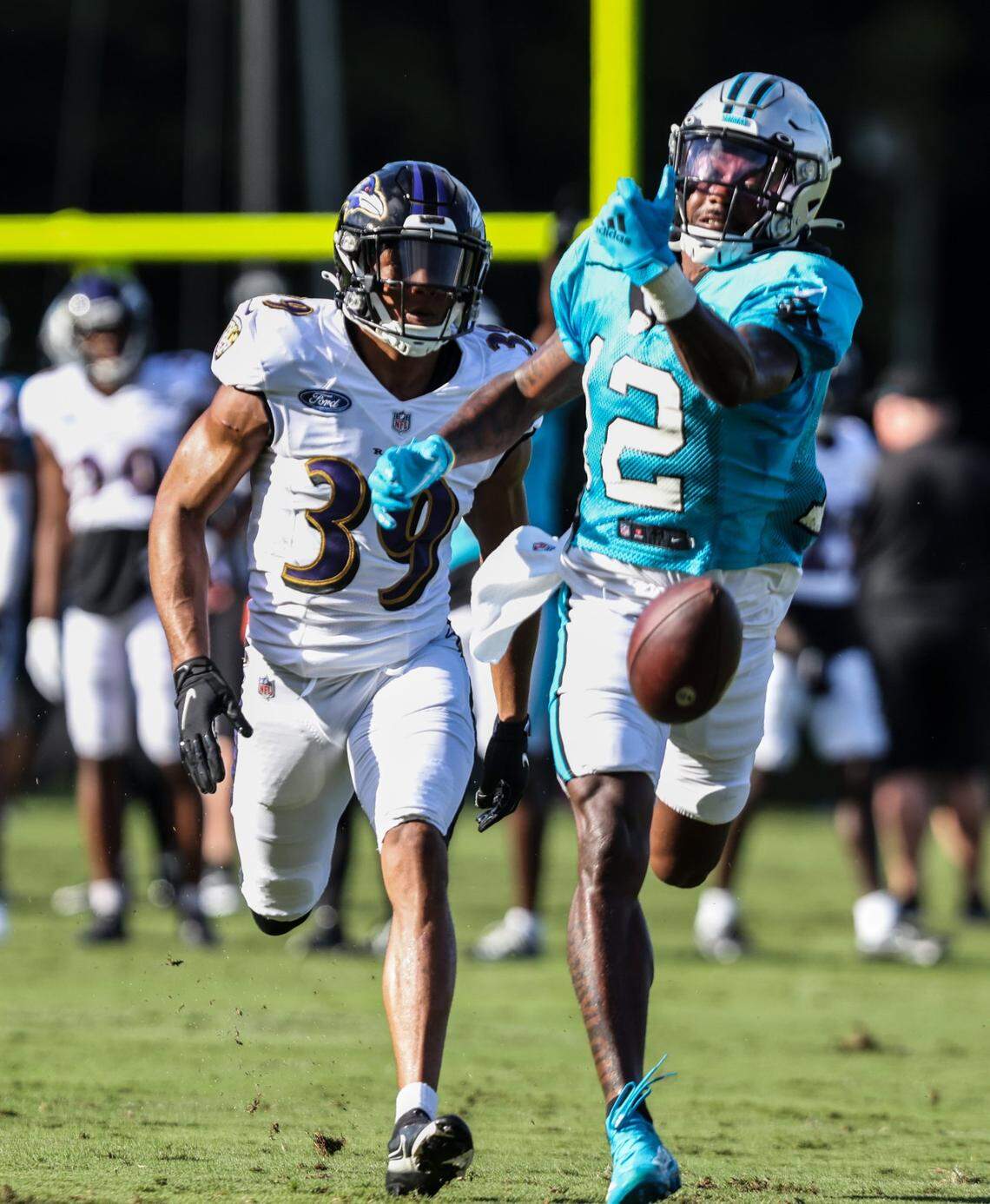 Carolina Panther rookie wide receiver Shi Smith (right) can’t catch up to a pass as Baltimore Ravens defensive back Nigel Warrior defends during the two teams’ joint practice in Spartanburg, S.C., Wednesday.