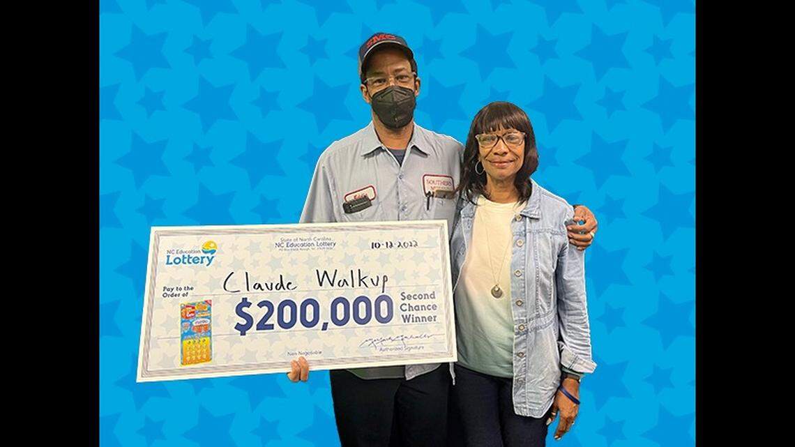 Claude Walkup, who won the first top prize in the new “The Price Is Right” N.C. scratch-off game, poses at lottery headquarters in Raleigh with his sister, Jessie Blair, on Wednesday, Oct. 12, 2022.