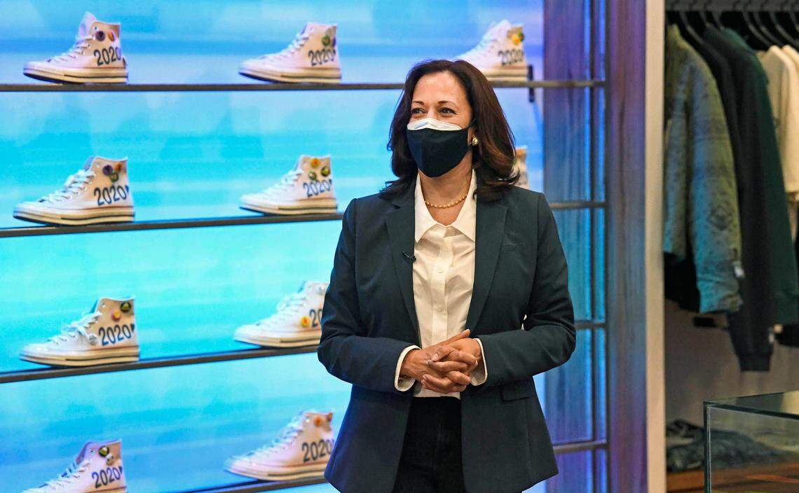 Democratic vice presidential candidate Sen. Kamala Harris stands near specially designed shoes in the store Social Status as owner James Whitner talks about them during a campaign stop in Charlotte on Wednesday.