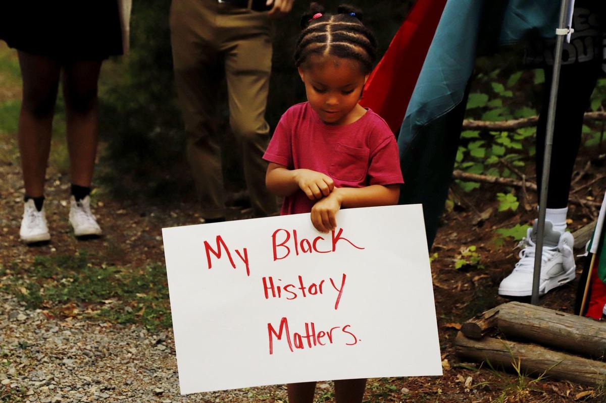 Baris Threatt, 3, holds a sign during the Juneteenth protest at the Latta Plantation in Huntersville, on Saturday, June 19, 2021.