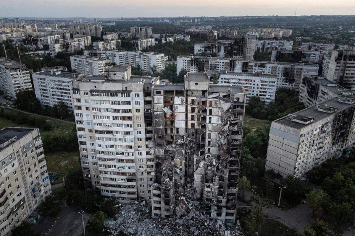 An Associated Press file photo shows an apartment building in the Bludovs’ hometown of Kharkiv, Ukraine, that was damaged by Russian attack.