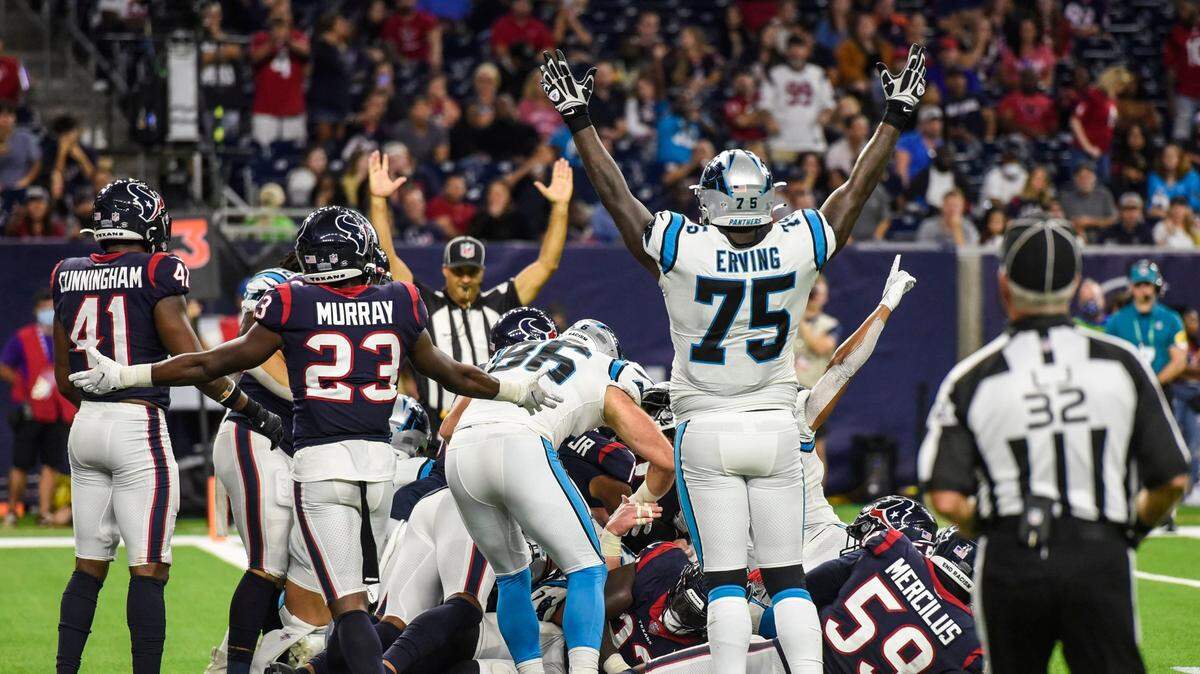 Panthers tackle Cameron Erving, front center, mirrors a referee by holding his arms up to signify a touchdown after quarterback Sam Darnold pushed his way into the end zone during the game at NRG Stadium on Thursday, September 23, 2021 in Houston, TX. The Panthers beat the Texans 24-9, giving them their third win in a row to start the season.