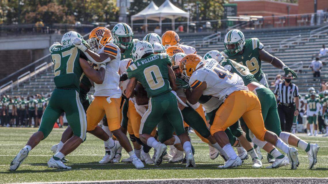 The Charlotte 49ers defense gang tackles UTEP on Saturday.