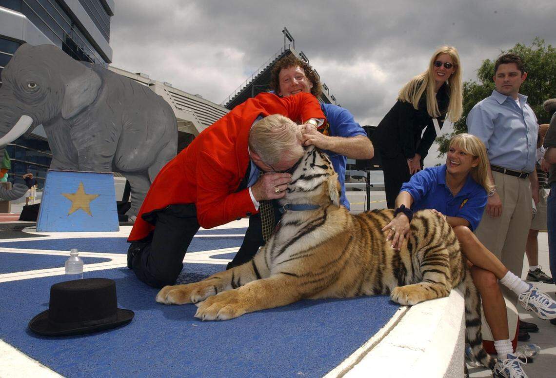 Charlotte Motor Speedway president H.A. "Humpy" Wheeler sticks his head in a tiger's mouth during a press conference.