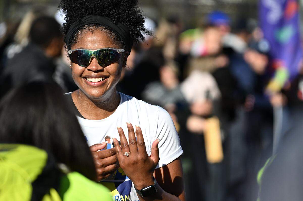 Alexis Montague smiles after getting engaged to her partner after taking part in the 20th annual Novant Health Charlotte Marathon on Saturday, Nov. 16, 2024, in Charlotte