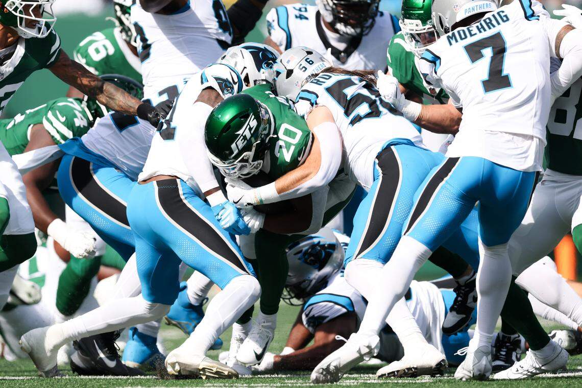 New York Jets running back Breece Hall (20) is tackled by Carolina Panthers linebacker Christian Rozeboom (56) in the first quarter at MetLife Stadium Oct. 19, 2025