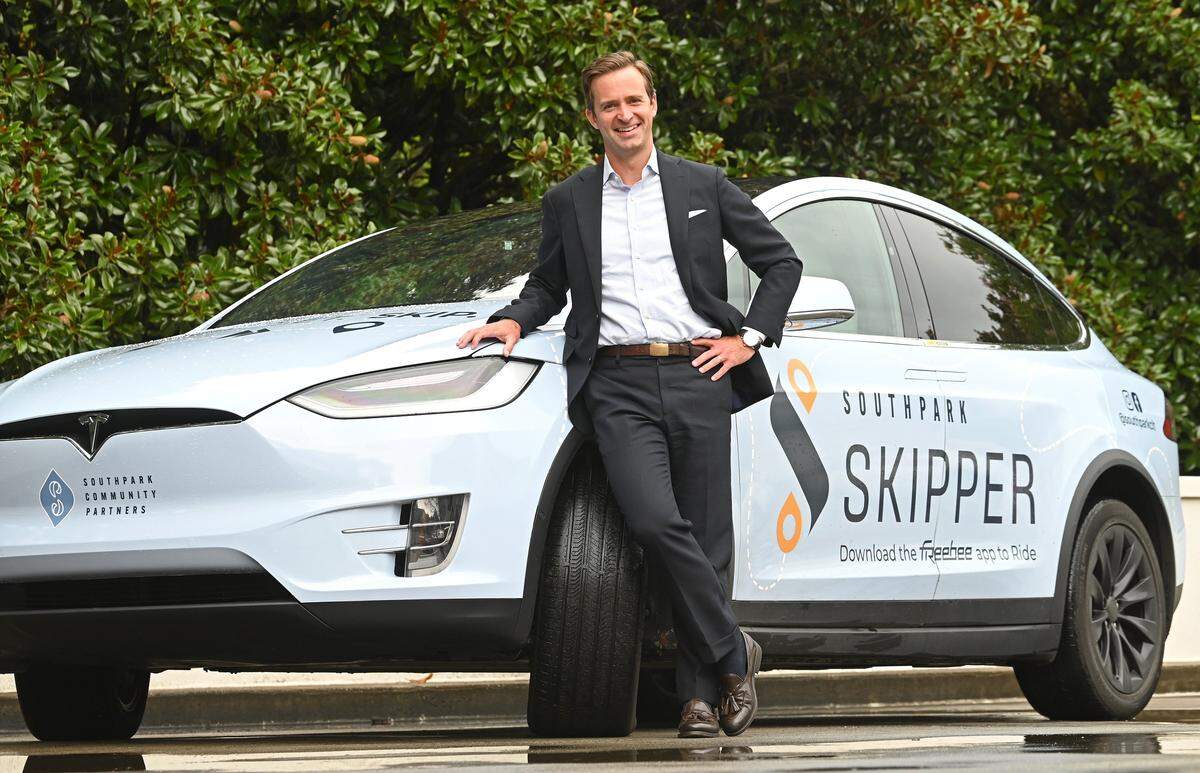 Adam Rhew, President and CEO of SouthPark Community Partners stands with one of the company's SouthPark Skipper cars on Monday, August 11, 2025. SouthPark Skipper is a free ride service that offers customers service within the SouthPark area in Charlotte, NC. The service runs every day from 9 a.m. to 9 p.m.