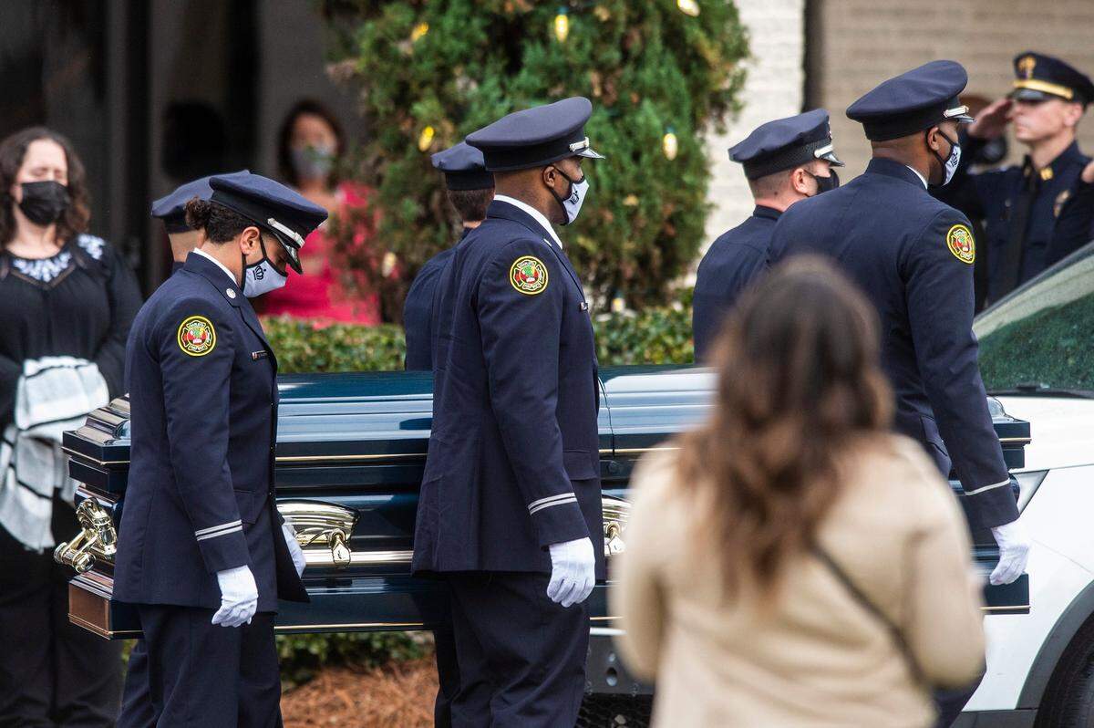 Pall barers with the police and fire department carry the casket of CMPD Officer Mia Goodwin at her funeral at First Baptist Church on South Davidson Street on Wednesday, December 29, 2021 in Charlotte, NC. Officer Goodwin was killed in a traffic-related incident on I-85 on December 22, 2021.