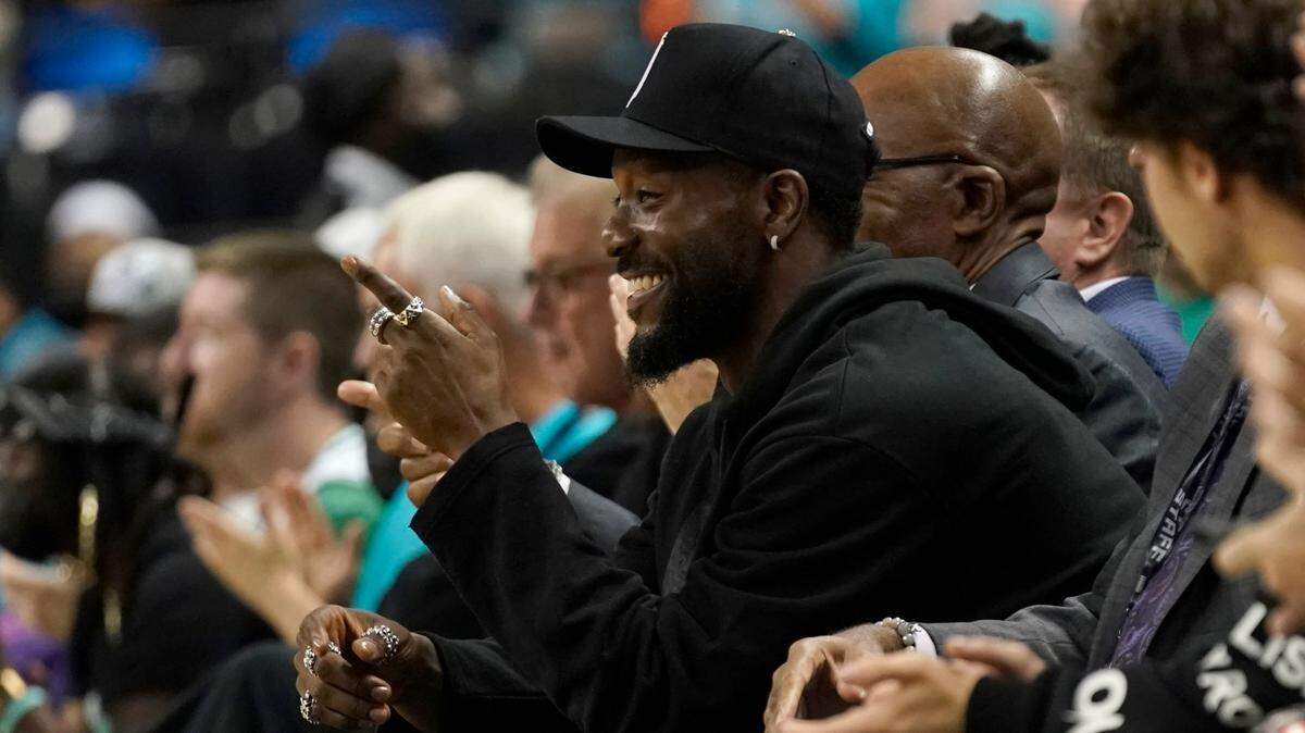 Former Charlotte Hornets and Boston Celtics player Kemba Walker watches the NBA preseason basketball game between the two teams in Greensboro, N.C., Friday, Oct. 7, 2022. (AP Photo/Chuck Burton)