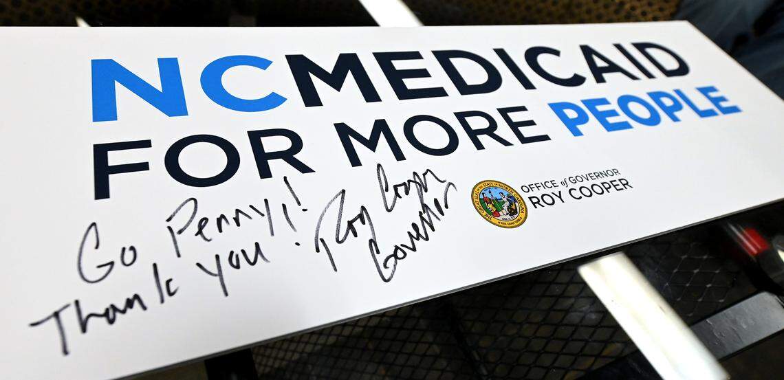 North Carolina Gov. Roy Cooper signed the placard that hung on the lectern where he announced that NC launched Medicaid expansion Friday.