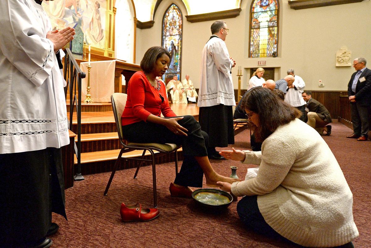 At St. Peter Catholic Church in uptown Charlotte, NC, priests and lay servers on Maundy Thursday imitate Christ by washing parishioners’ feet, as Jesus did for his disciples.