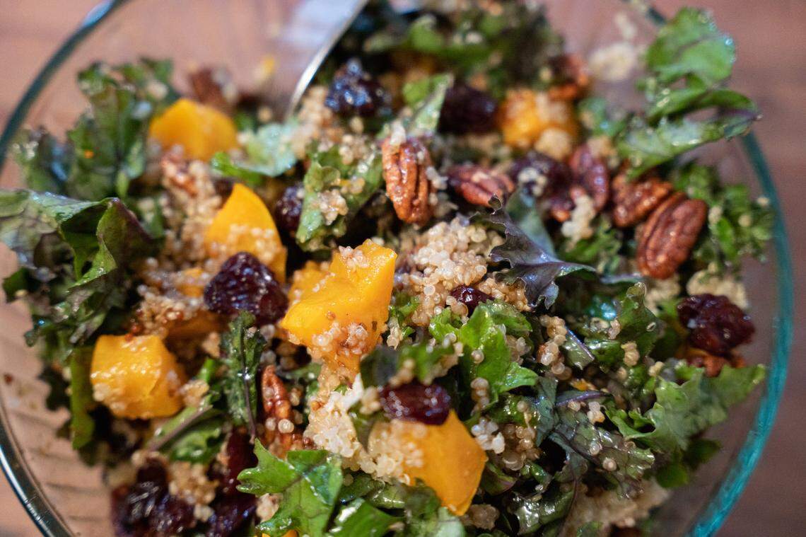 A close-up photo of salad with kale, quinoa and butternut squash.