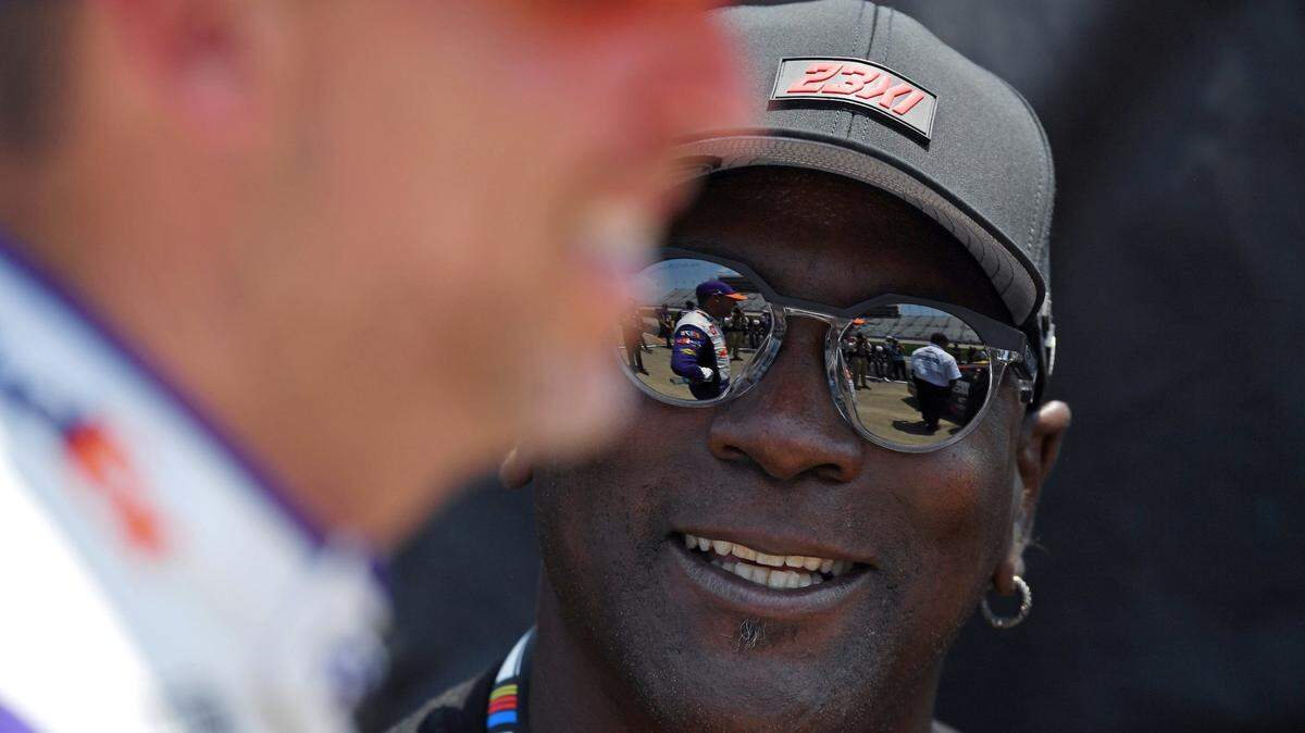 Jun 24, 2023; Nashville, Tennessee, USA; Team 23XI owner Michael Jordan talks with NASCAR Cup Series driver Denny Hamlin (11) after his first qualifying run for the Ally 400 at Nashville Superspeedway. Mandatory Credit: Christopher Hanewinckel-USA TODAY Sports