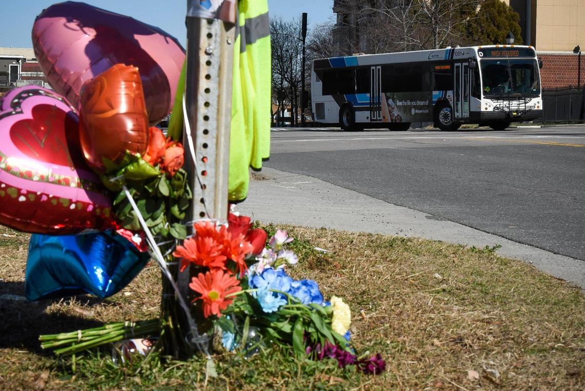 A Charlotte Area Transit System bus passes near a memorial for slain CATS bus driver Ethan Rivera along South Graham Street near West Trade Street in Charlotte, N.C. Monday, Feb. 14, 2022. Rivera was shot while working on Friday night and died from his injures early Saturday morning.