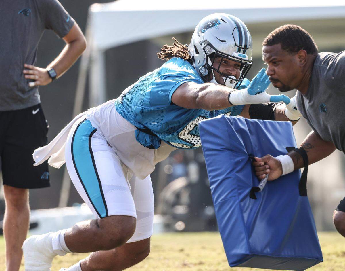 Carolina Panthers Austin Larkin, left, hits a pad during a drill at the Carolina Panthers training camp at Wofford College in Spartanburg, S.C., on Monday, August 2, 2021.
