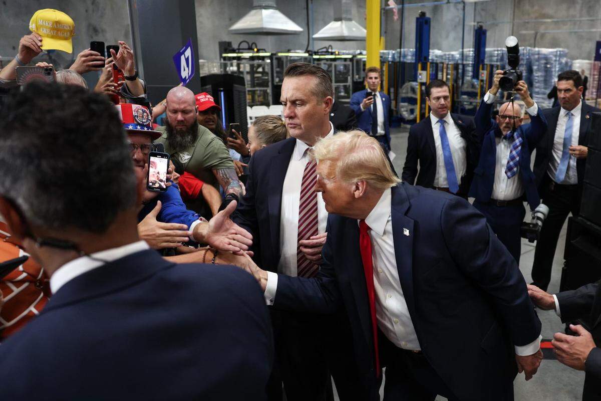 Former President Donald Trump shakes hands with supporters a campaign rally inside the Mosack Group manufacturing warehouse in Mint Hill, NC on Wednesday, September 25, 2024.