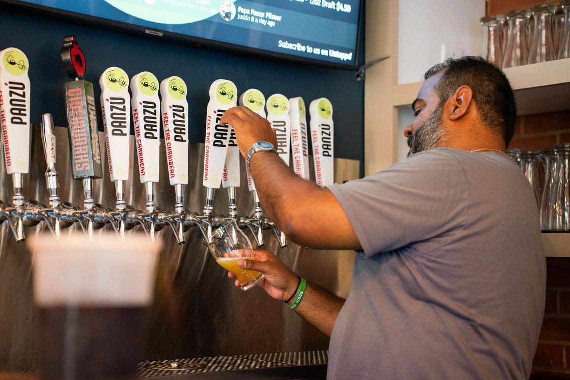 Johan Marte fills a pint July 12, 2024, at Caribbean-themed Panzú Brewery in Mint Hill, near Charlotte.
