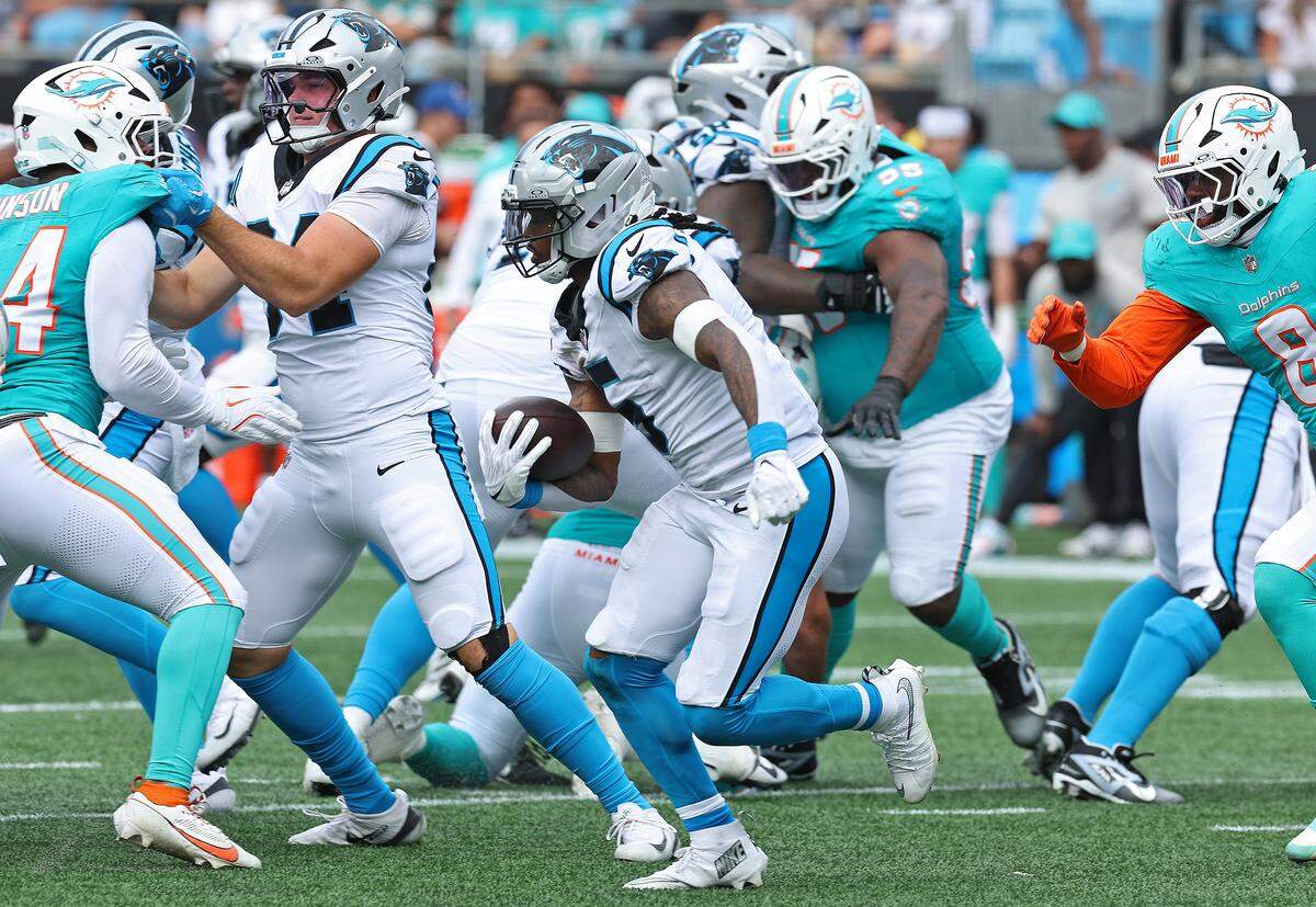 Carolina Panthers running back Rico Dowdle, center, breaks to the outside on a run during action against the Miami Dolphins on Sunday, October 5, 2025 at Bank of America Stadium in Charlotte, NC. The Panthers defeated the Dolphins 27-24.