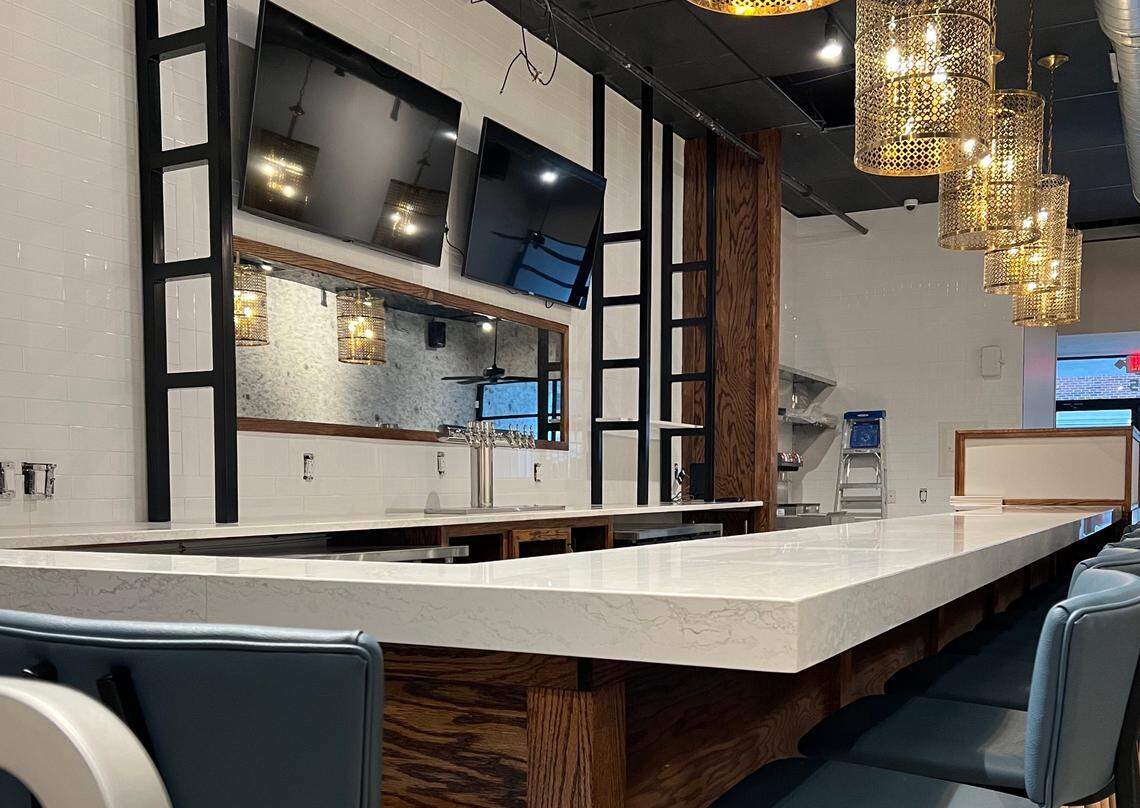 Two televisions hang above the bar at Hawthorne’s NY Pizza & Bar in Concord.