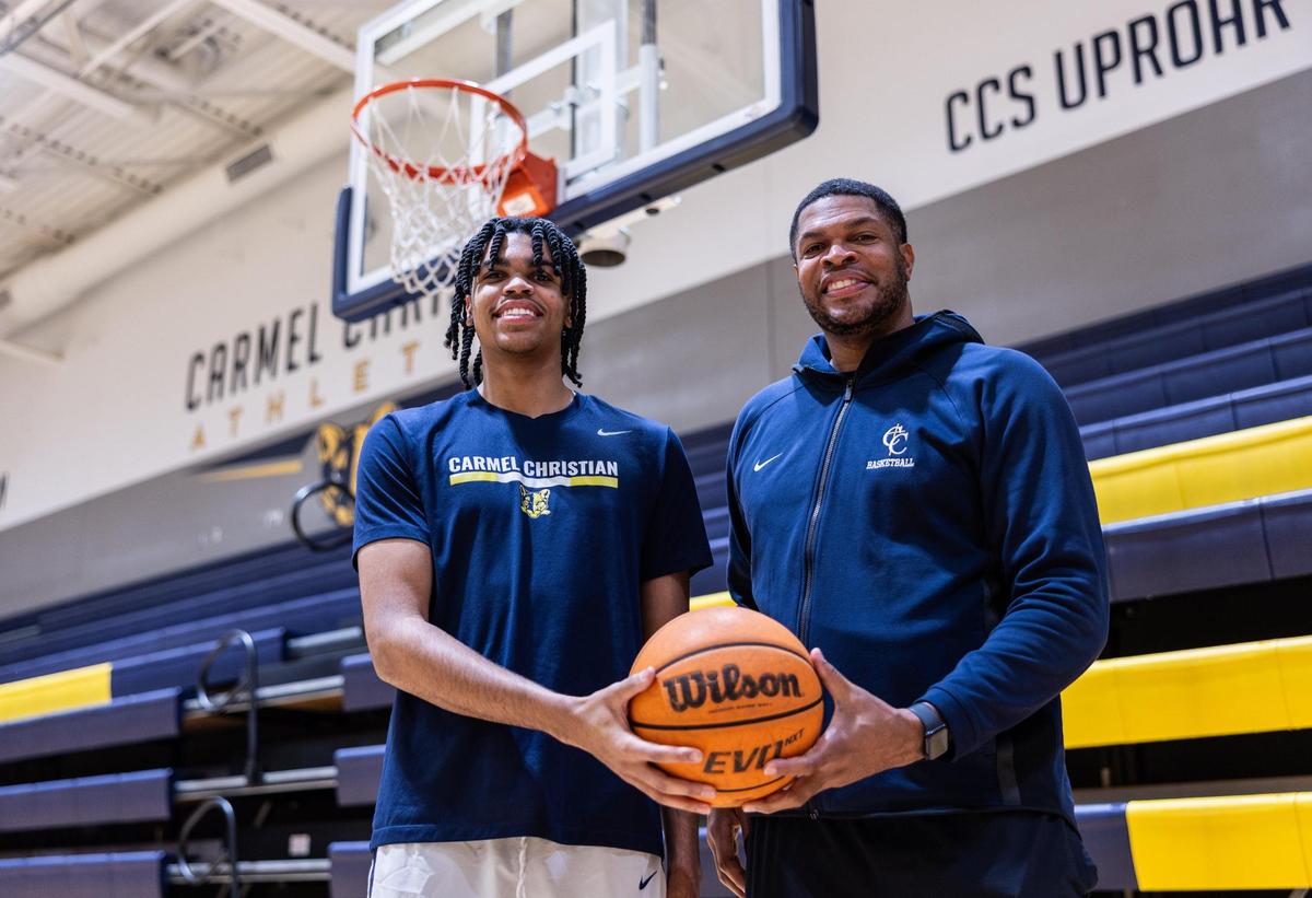 Bryce Slay, left, poses for a portrait with his dad, Tamar Slay at Carmel Christian in Charlotte, N.C., on Monday, December 16, 2024.