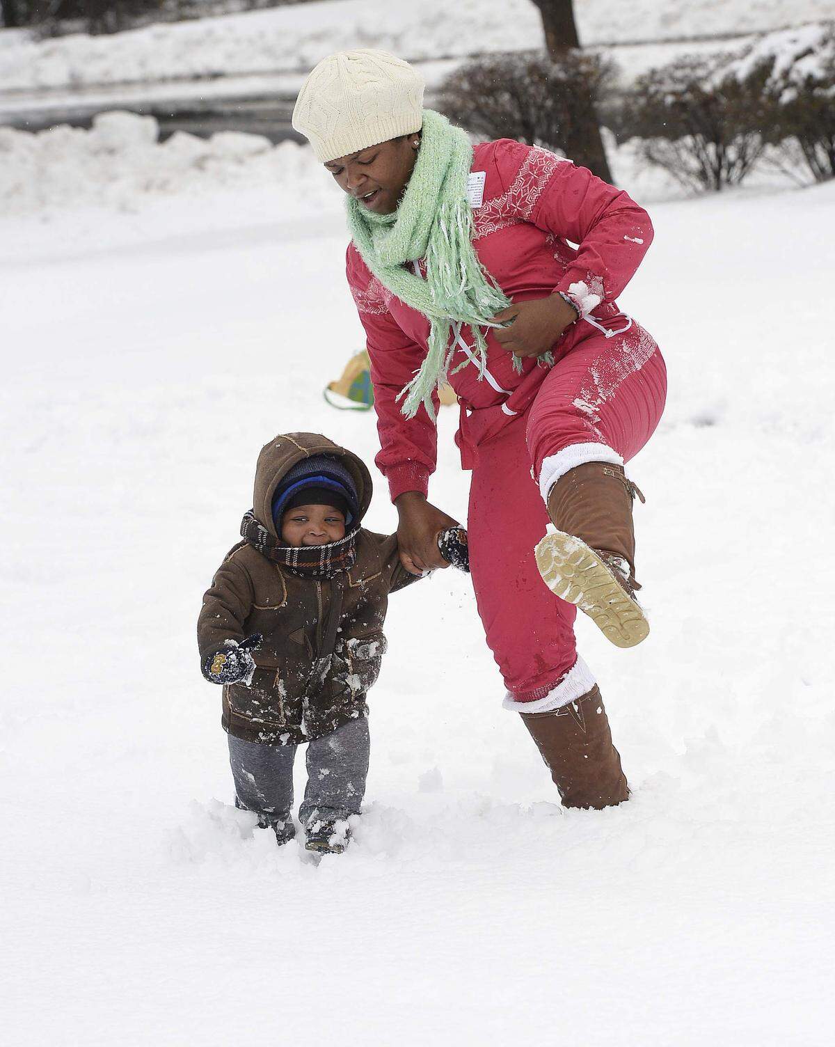 Tammy Holloway plays in the snow with her son Nile River Holloway, age 18 months, at their home on West Boulevard in Charlotte on Feb. 13, 2014.
