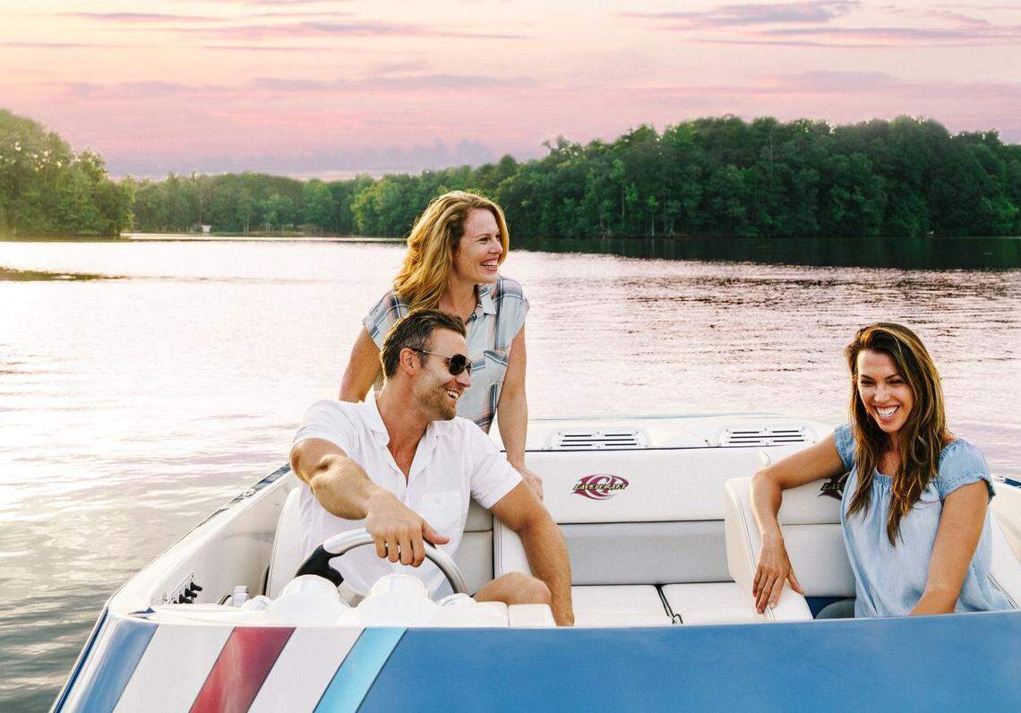 Visitors take a boat ride on High Rock Lake at sunset.