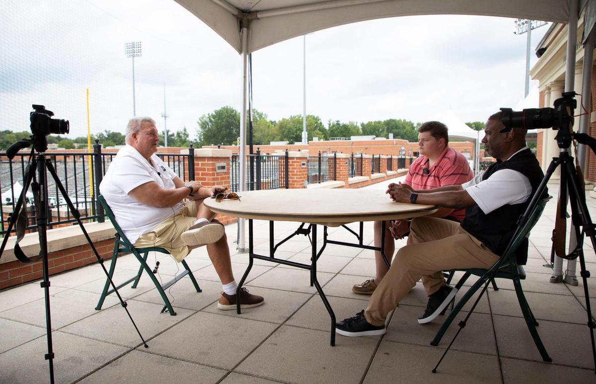 From left to right, Charlotte 49ers coach Biff Poggi, answers questions from Cameron Williams and Langston Wertz Jr., at Jerry Richardson Stadium for the latest episode of Talking Preps.