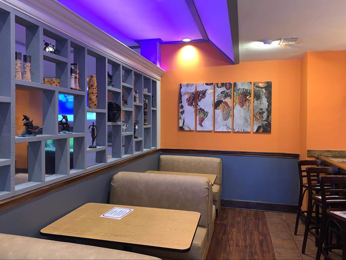 A wall of spices, cooking oils and authentic Thai fixtures line the center of the restaurant.