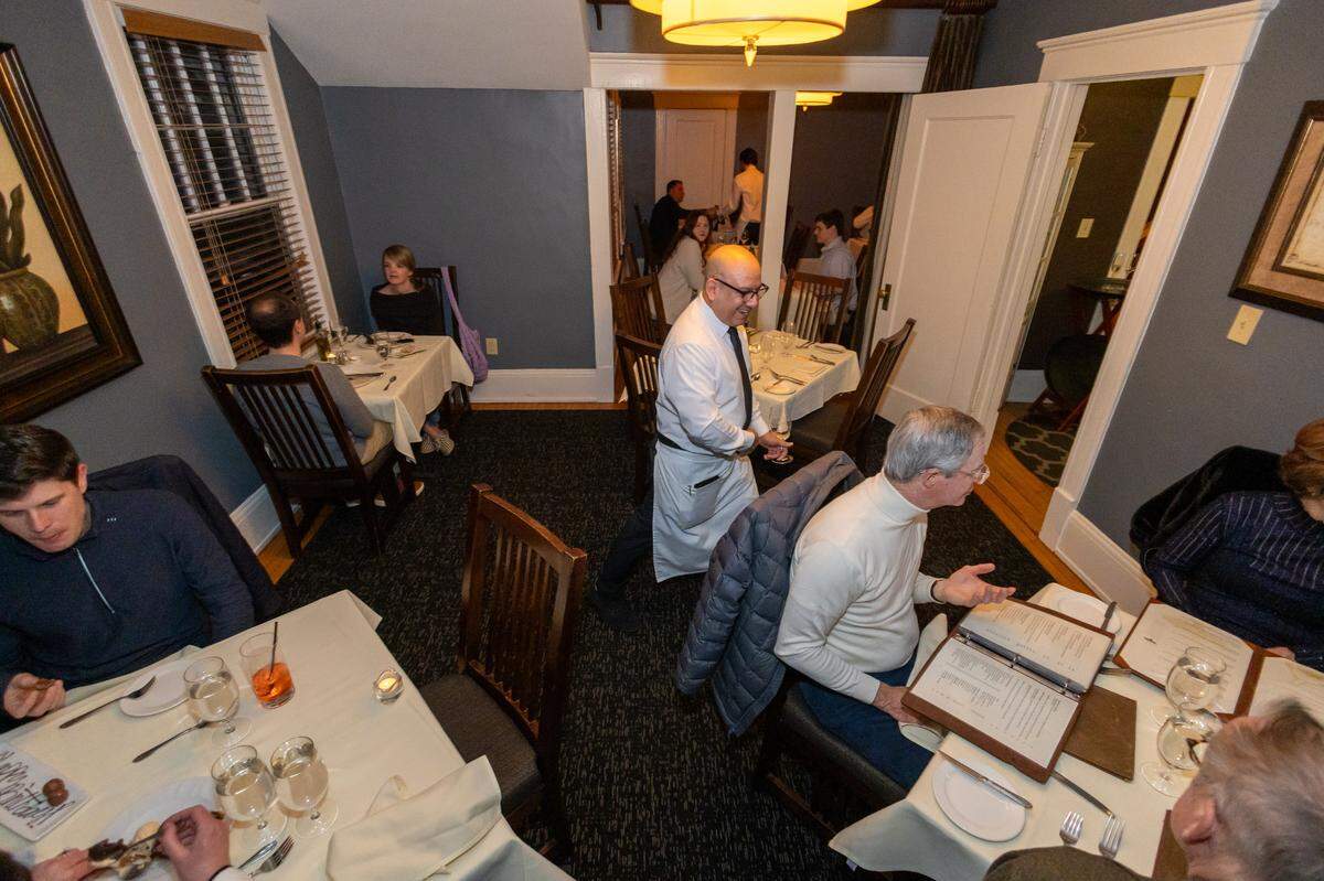 Fernando Cruz Flores serves tables on the second story of The Fig Tree restaurant.