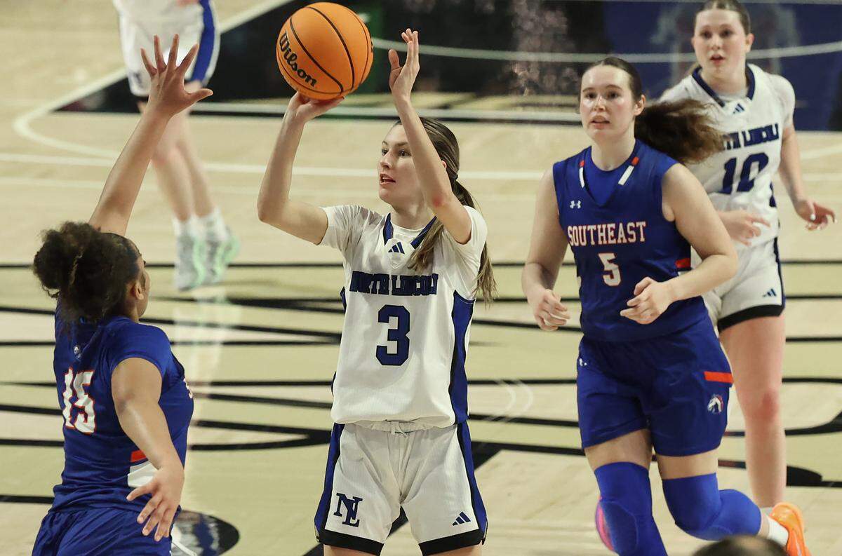 North Lincoln’s Ally Smith, right, releases a jumper over the outstretched arm of SE Alamance defender Inysia McIver, left, during the 5A girls’ championship game on Saturday at Lawrence Joel Veterans Memorial Coliseum in Winston-Salem North Lincoln defeated SE Alamance 59-56.
