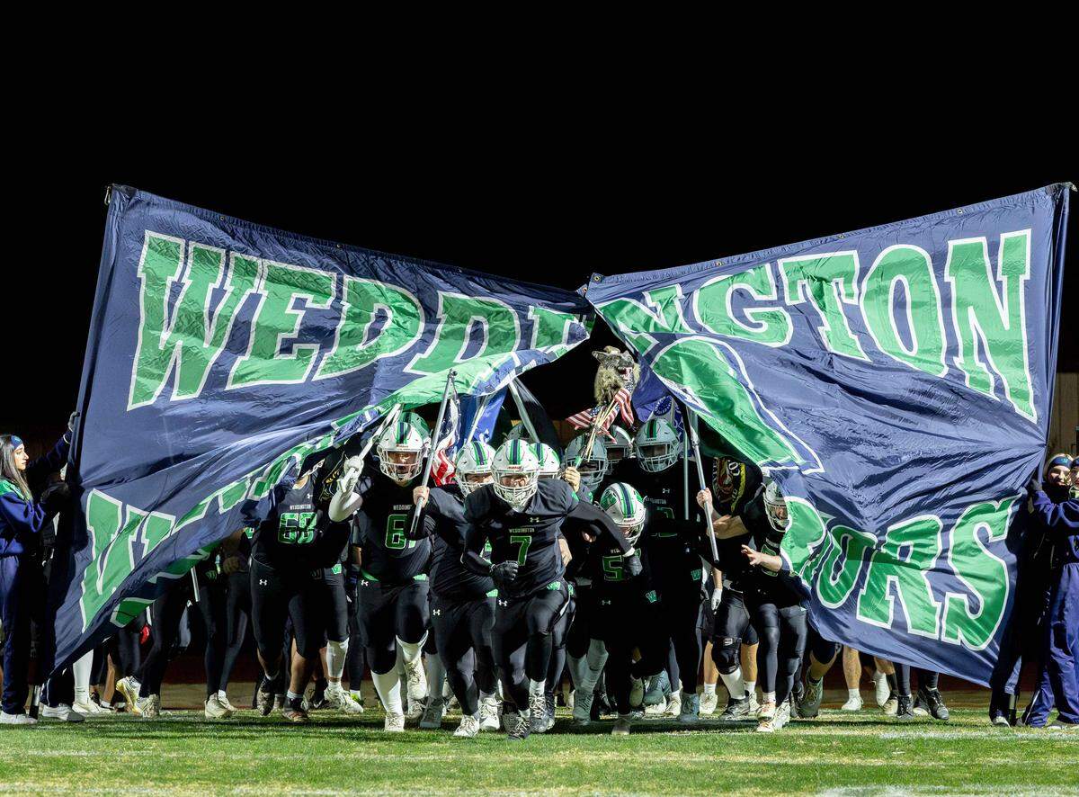 The Weddington Warrior's take the field for their NCHSAA quarterfinal playoff game against their cross town rivals the Independence Patriots Friday November 28, 2025.