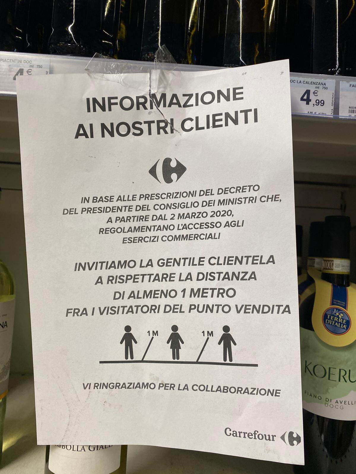 A taped-up sign in a Carrefour retail store in Milan, Italy, advises all customers to stay at least one meter away from each other at all times due to the coronavirus.