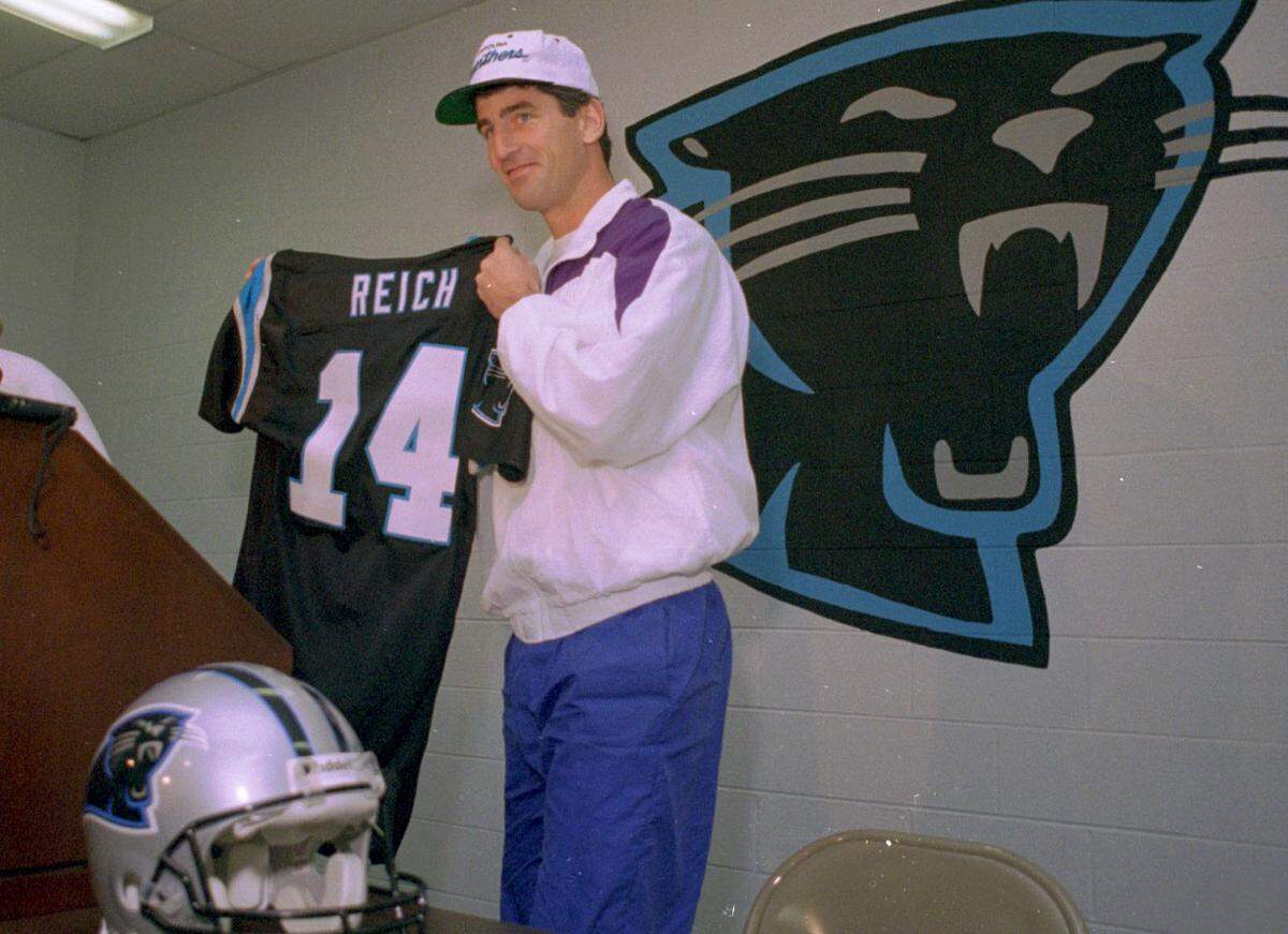 Frank Reich shows off his jersey shortly after the Carolina Panthers signed him in March 1995.