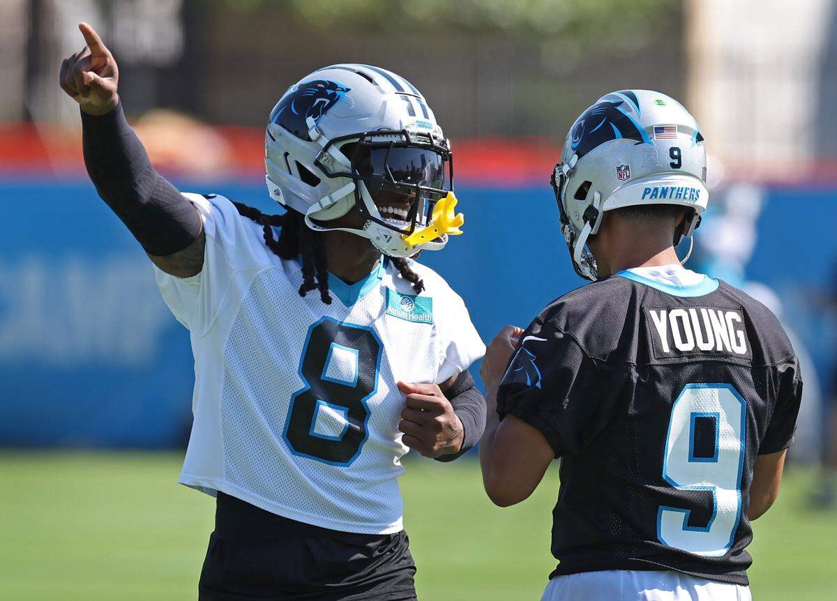 Carolina Panthers cornerback Jaycee Horn (left) has a running verbal battle going in practice with quarterback Bryce Young.