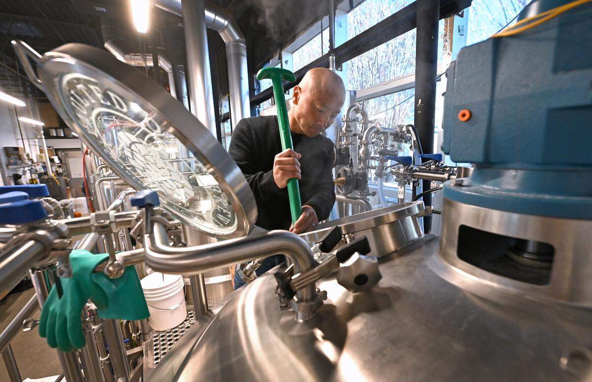 Théoden Janes stirs the "porridge" that will become his beer at Vaulted Oak Brewing.