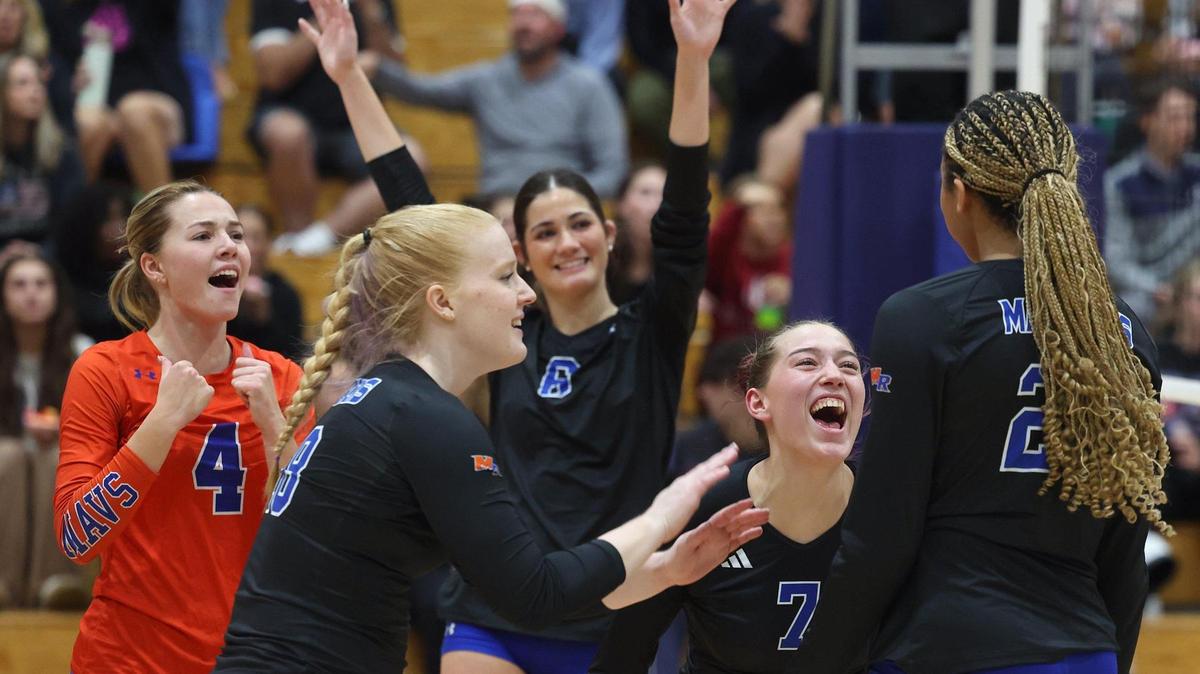 Members of the Marvin Ridge High girls volleyball team congratulate teammate Victoria Simons, right, on a scoring play against Northern Guilford during NC 4A quarterfinal volleyball playoff action at Marvin Ridge High School on Tuesday, October 29, 2024. Marvin Ridge defeated Northern Guilford 3-0.