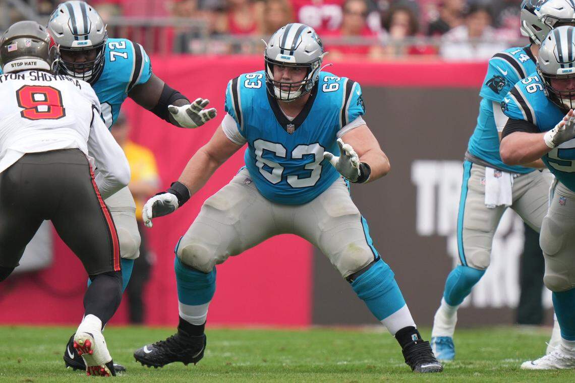 Carolina Panthers guard Austin Corbett (63) looks to block an incoming Tampa Bay Bucs defender during the 2022 NFL season. Corbett tore his ACL on Jan. 8, 2023, and is still recovering from that injury.