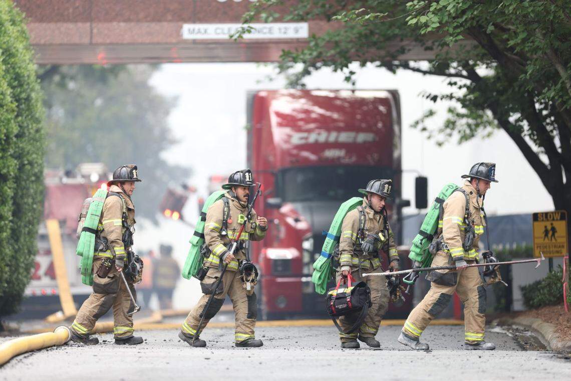 Fire fighters work the scene at a fire in Charlotte’s South Park neighborhood Thursday morning.