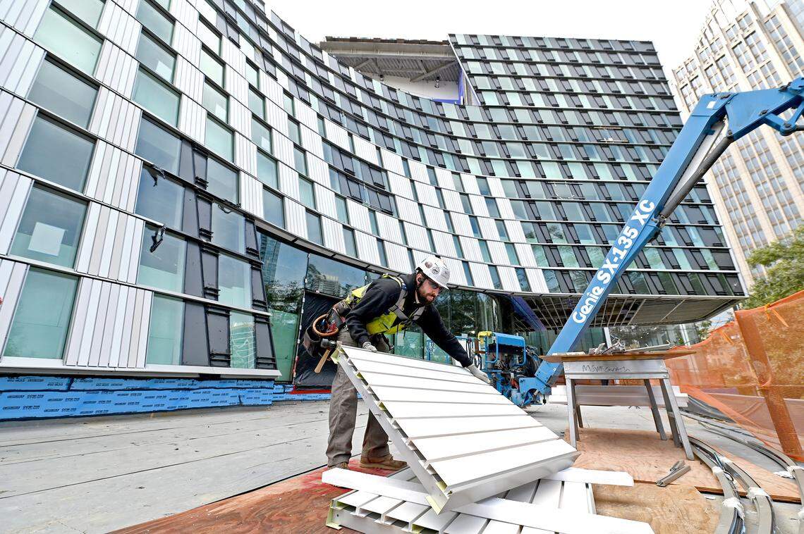 A subcontractor unloads architectural metal panels to be used on the exterior of the Charlotte Mecklenburg Library’s new Main Library on North Tryon Street.