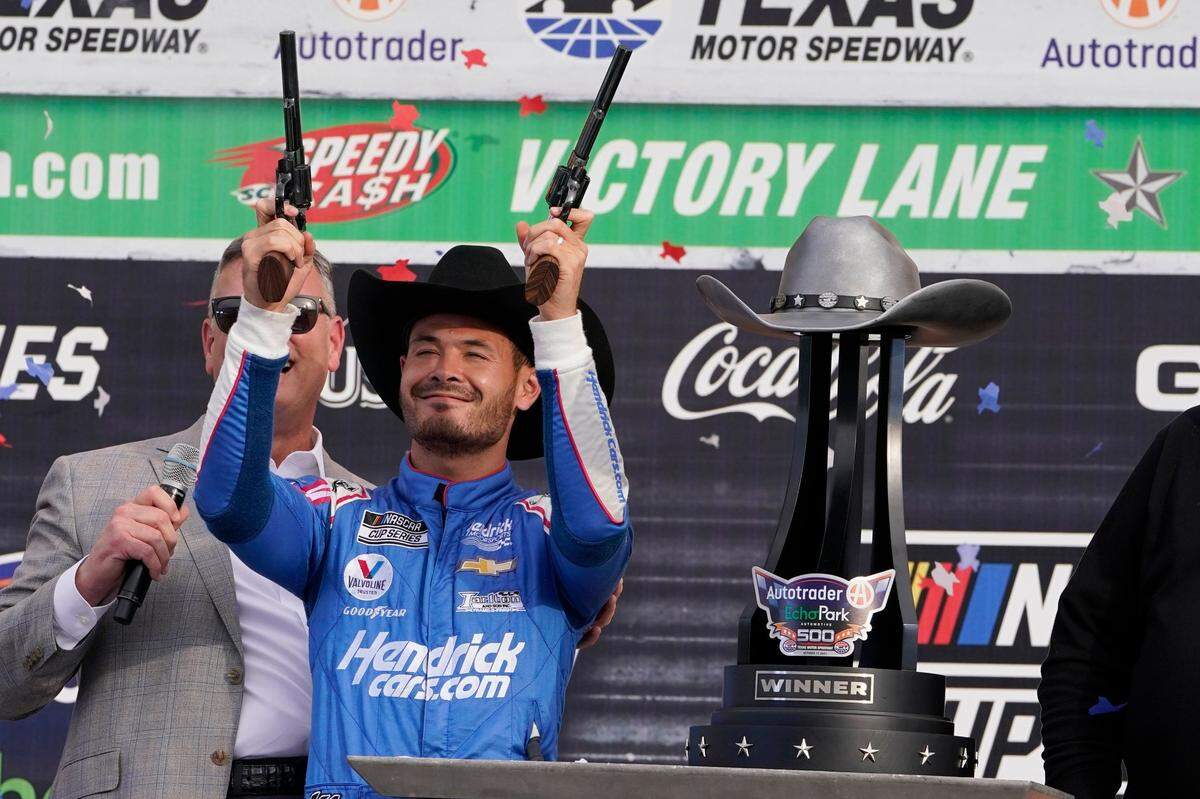 Winning driver Kyle Larson celebrates with the obligatory six-shooters photo opp after taking his second straight checkered flag in Sunday’s NASCAR Cup Series playoff race at Texas Motor Speedway in Fort Worth, Texas.