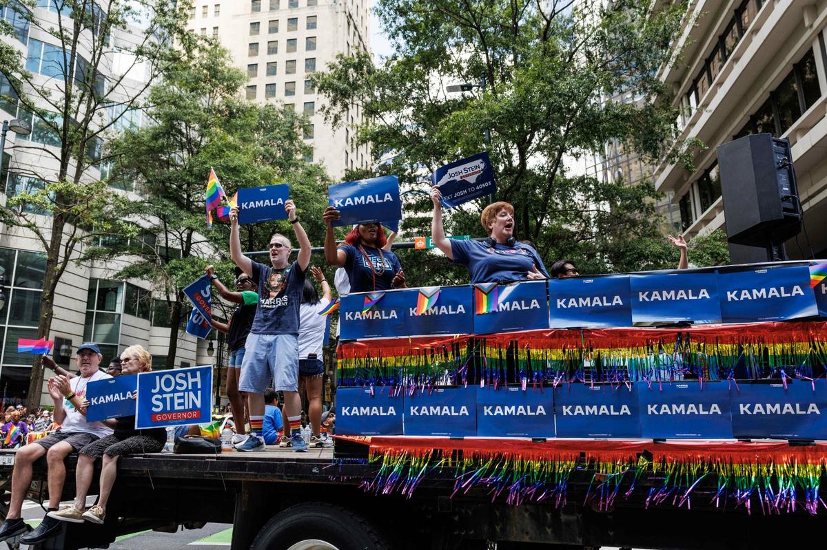 Participants wave signs that read “Kamala” and “Josh Stein,” showing support for the upcoming November election during the Charlotte Pride Festical & Parade on Sunday, Aug. 18, 2024
